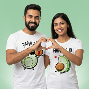 Mamacado Papacado matching couple t-shirts — Indian couple making heart gesture for pregnancy announcement photoshoot